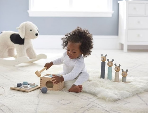 Child playing with wooden toys