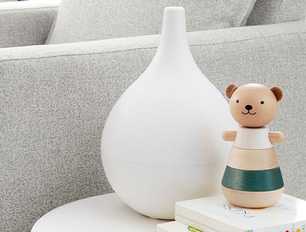 White humidifier next to children's toy.