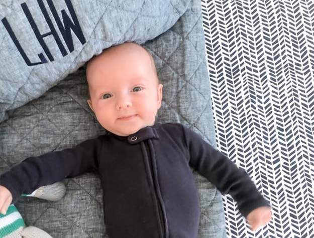 Baby with monogrammed blanket