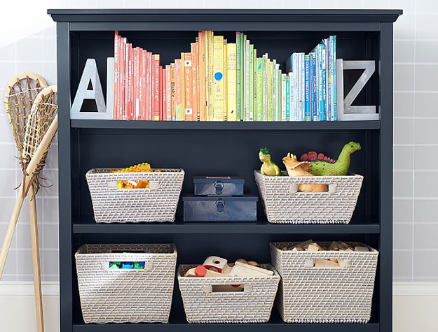 Color-coded books in navy blue bookshelf