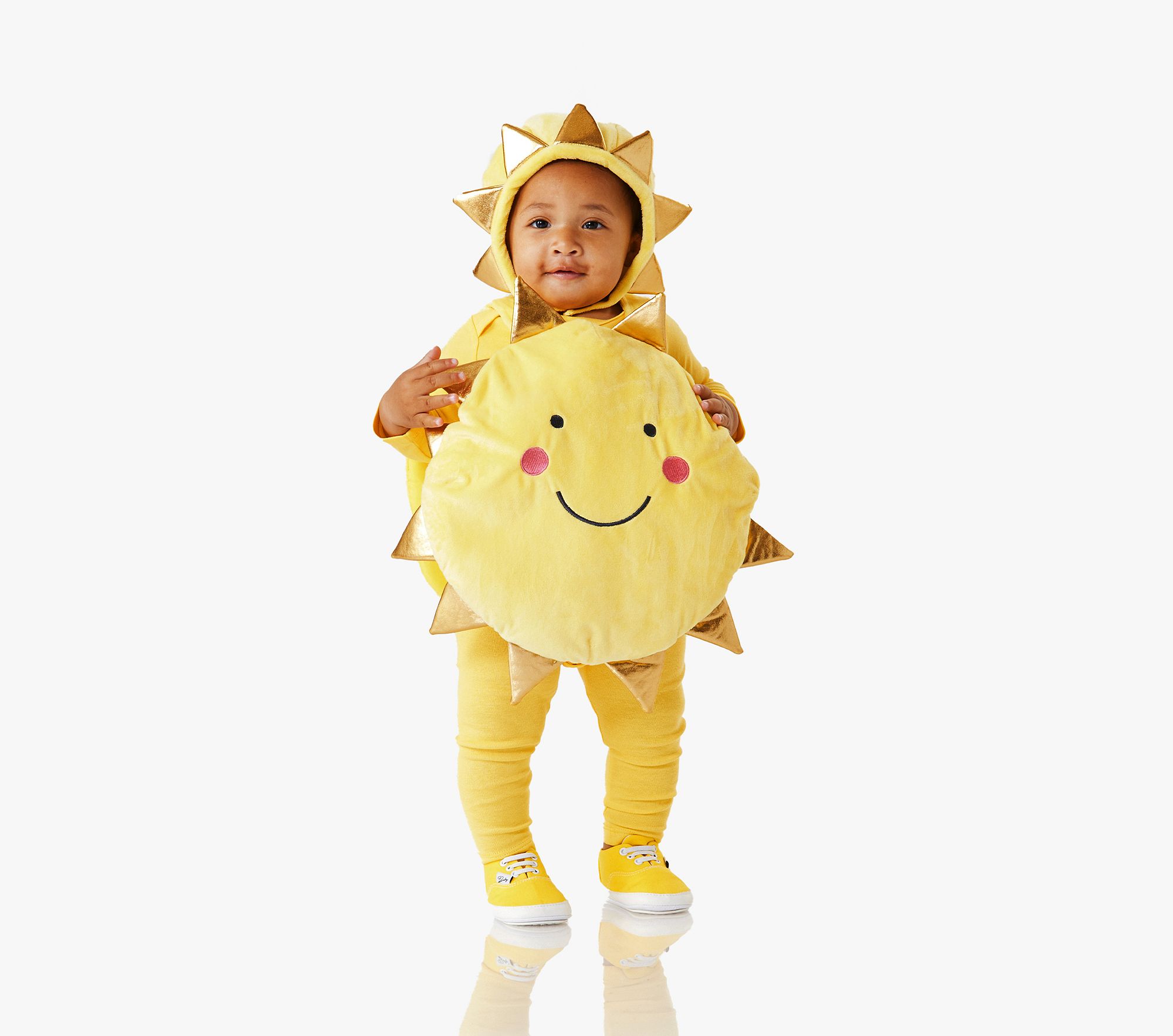 A baby wearing a yellow smiling sun costume